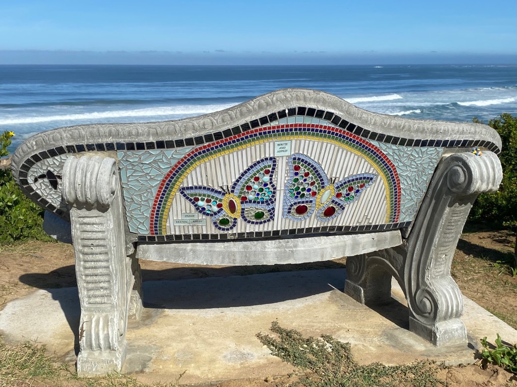 Beautiful mosaics decorate the benches along the cliff top at Brenton-on-sea